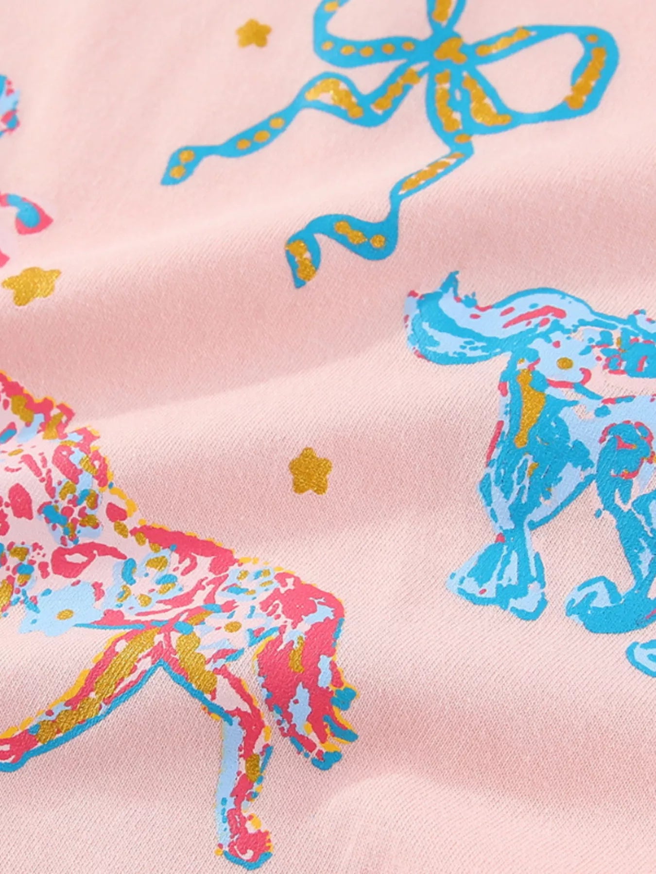 Close view of the colourful horse and bow print on the pink children's short sleeve tee