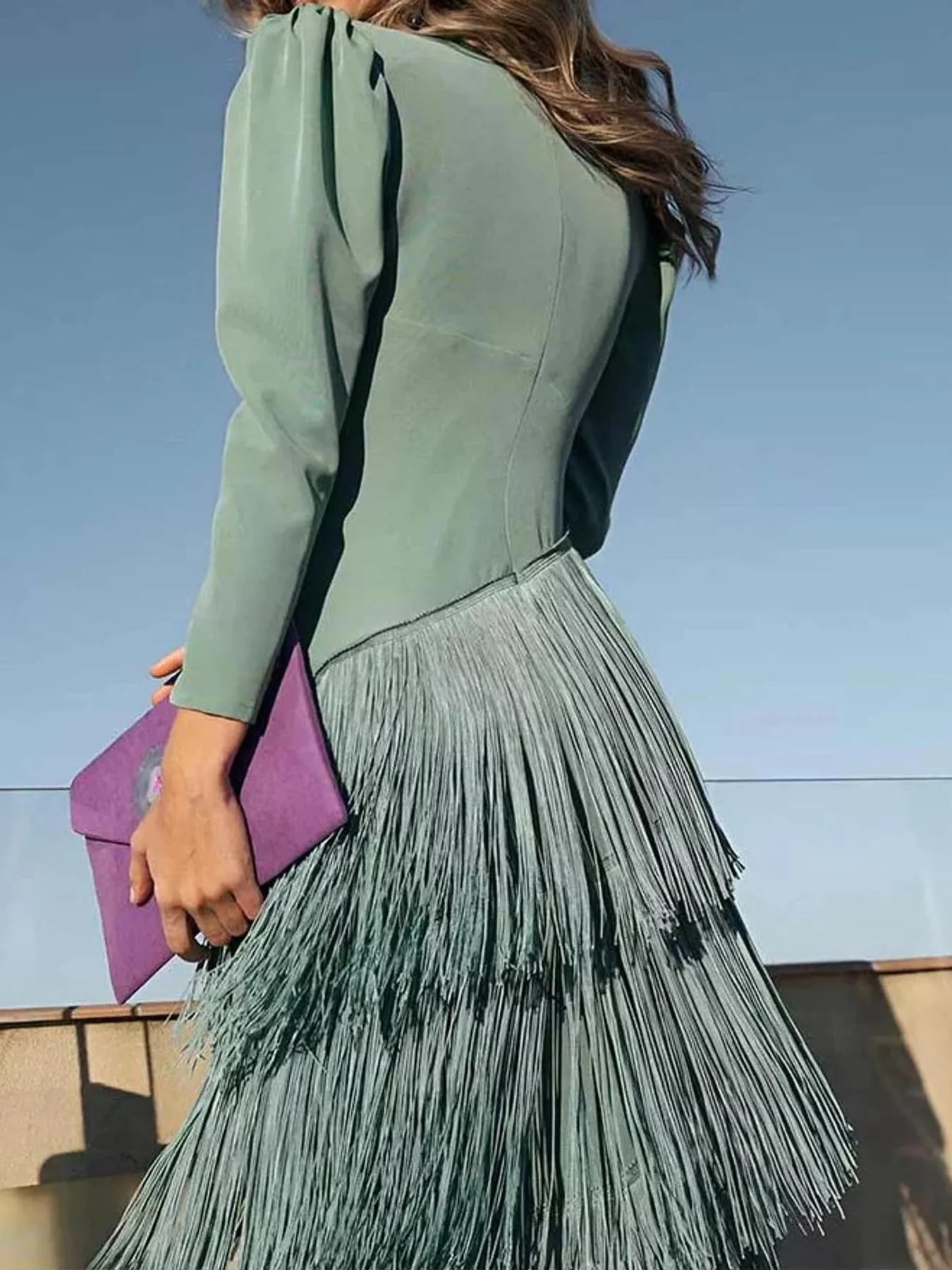 Back view of a gum leaf green fringed maxi dress with puff sleeves and layered fringe