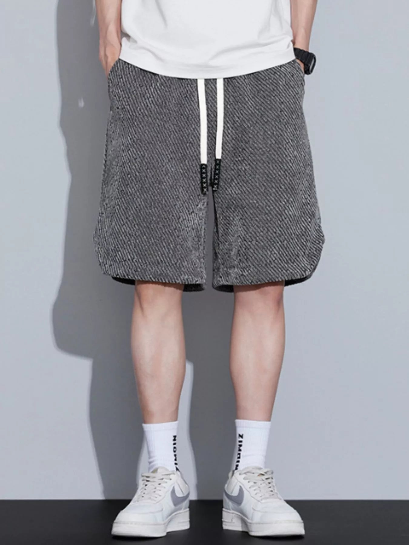 Men's loose fit shorts with a drawstring waist and pockets.
