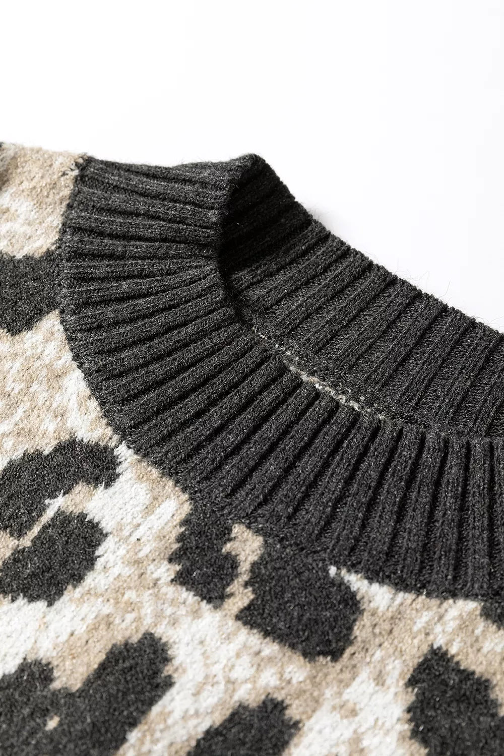 Close up detail of the ribbed collar on the gray and black leopard print baggy sweater.