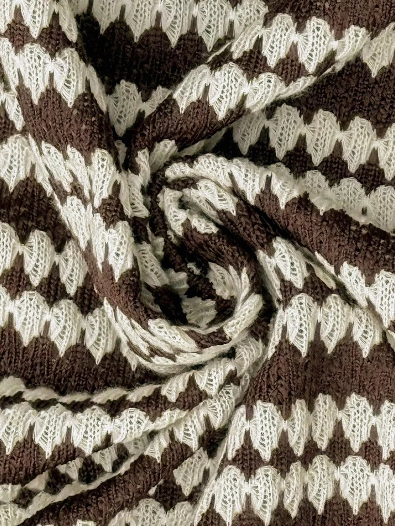 Extreme close-up of the brown and cream striped knit texture of the sweater dress fabric