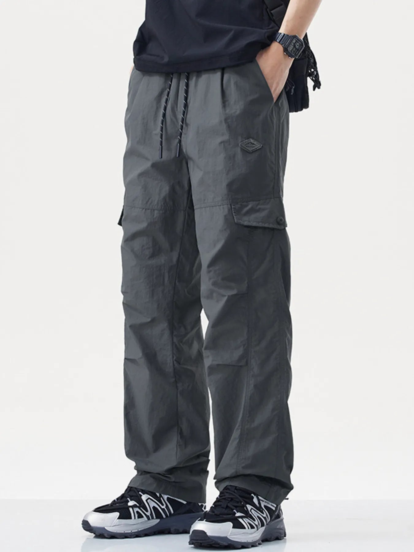 Men's plus size relaxed fit cargo pants with drawstring and pockets, product fit view.