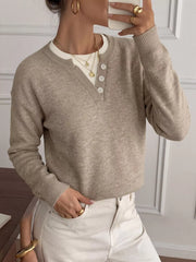 Close mirror view of khaki dropped shoulder sweater with button placket and layered top