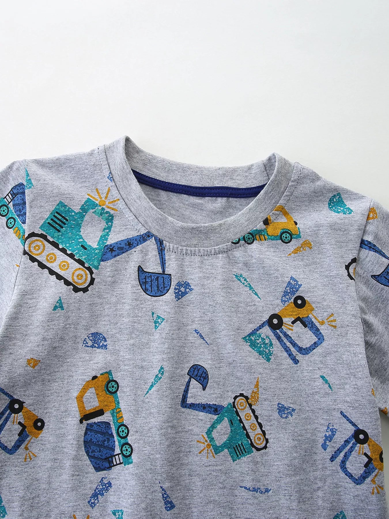 Close up of the round neckline on a gray children's excavator print tee