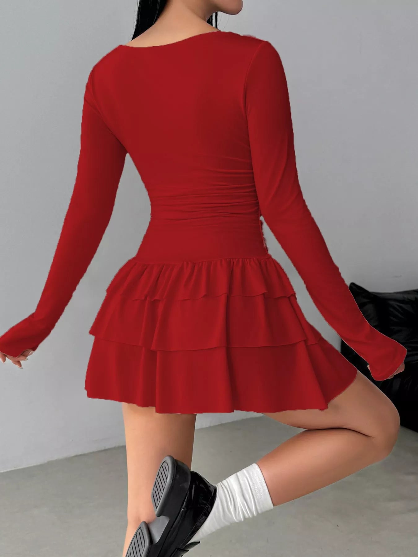 Red layered ruffle long sleeve mini dress worn from the back showing the ruched waist
