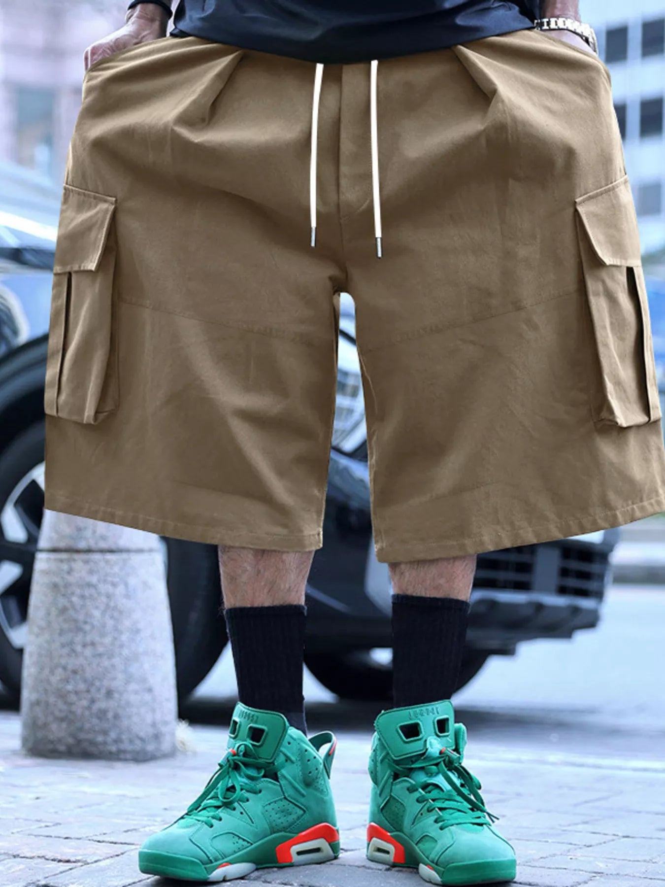 Men's khaki cargo shorts with a drawstring waist and pockets.