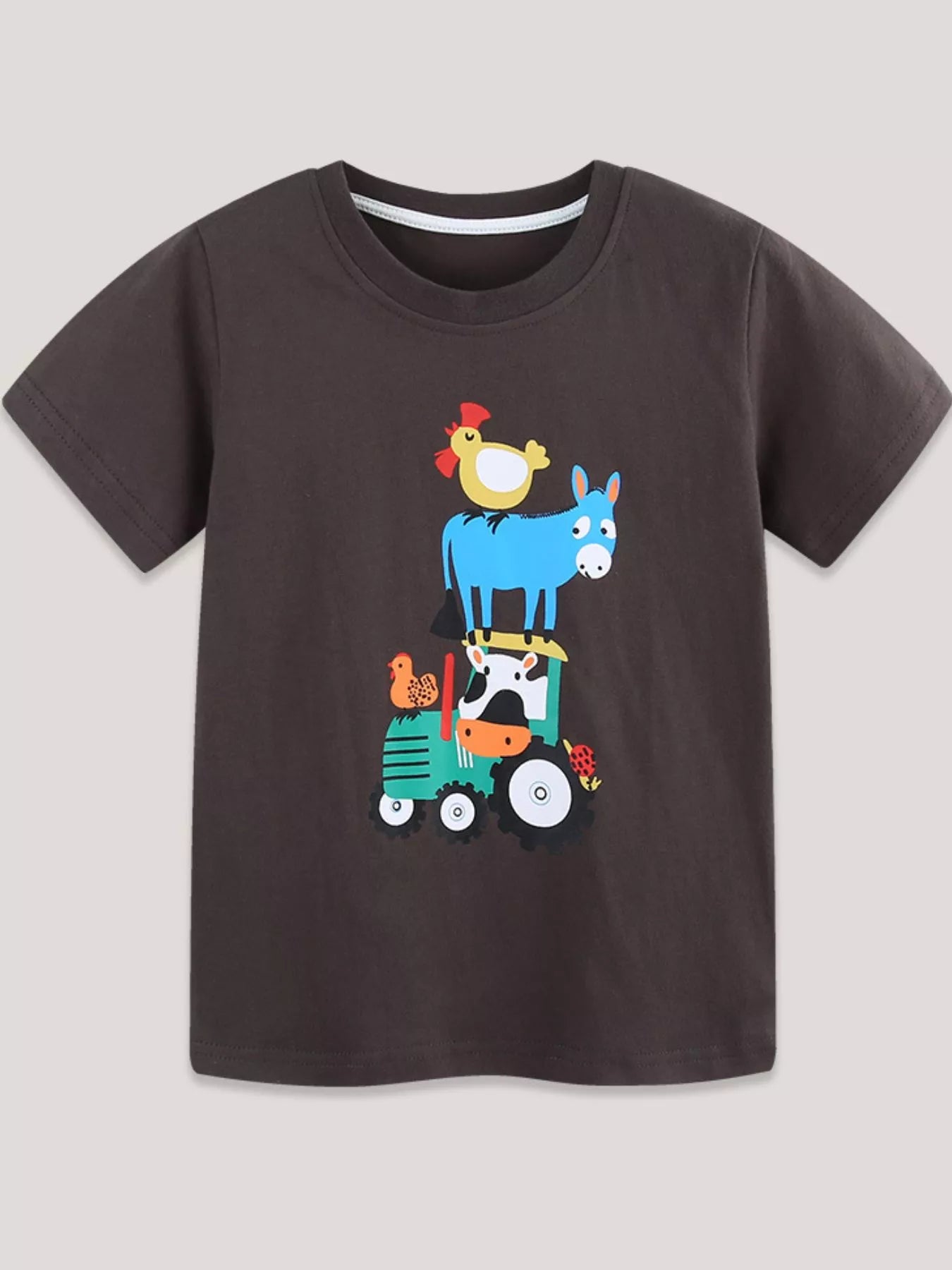 Chocolate children's short sleeve t-shirt laid flat with farm animals on a green tractor print