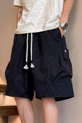 Men's black drawstring shorts with pockets and lightweight fabric.