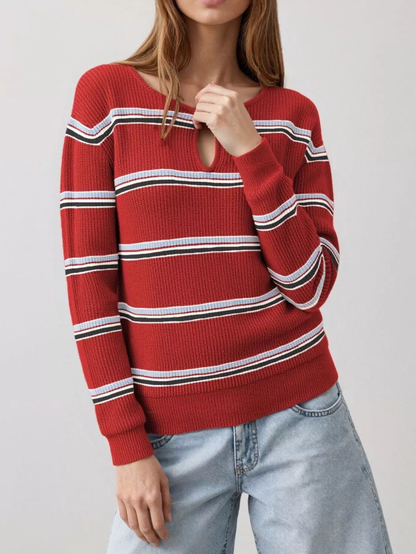 Front view of a red striped ribbed knit top with a keyhole neckline