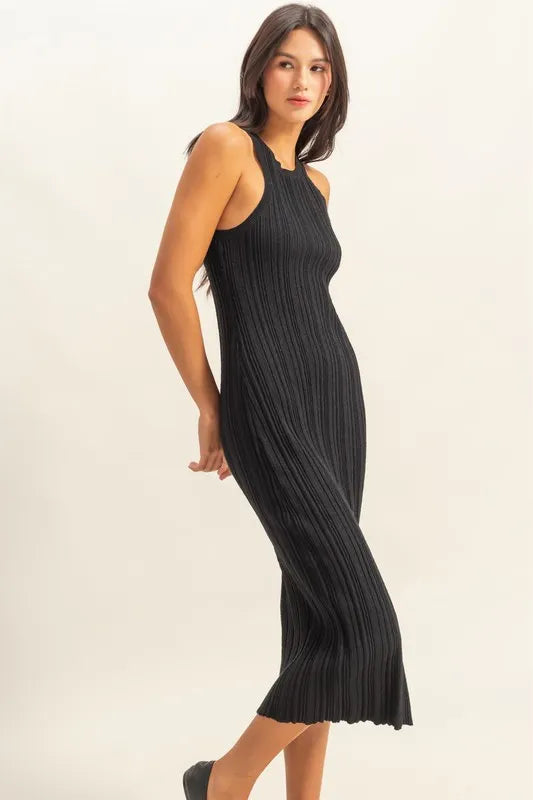 Black sleeveless ribbed knit bodycon dress with round neck, side view on model
