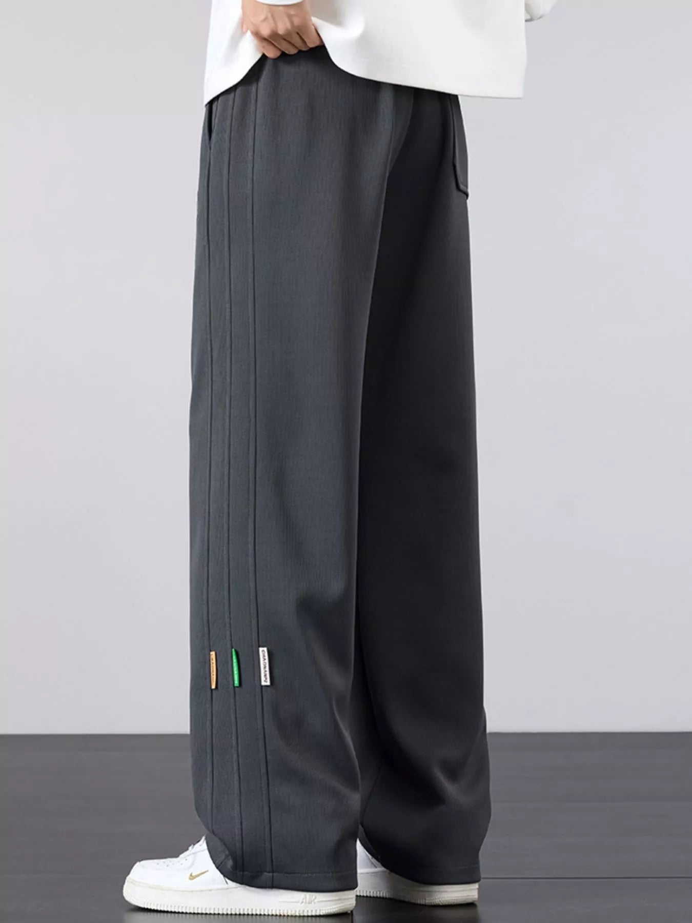 Men's casual loose fit pants with a drawstring waist and pockets.