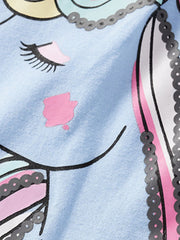 Close-up of the unicorn face with a pink cheek and sequin trimmed colorful mane