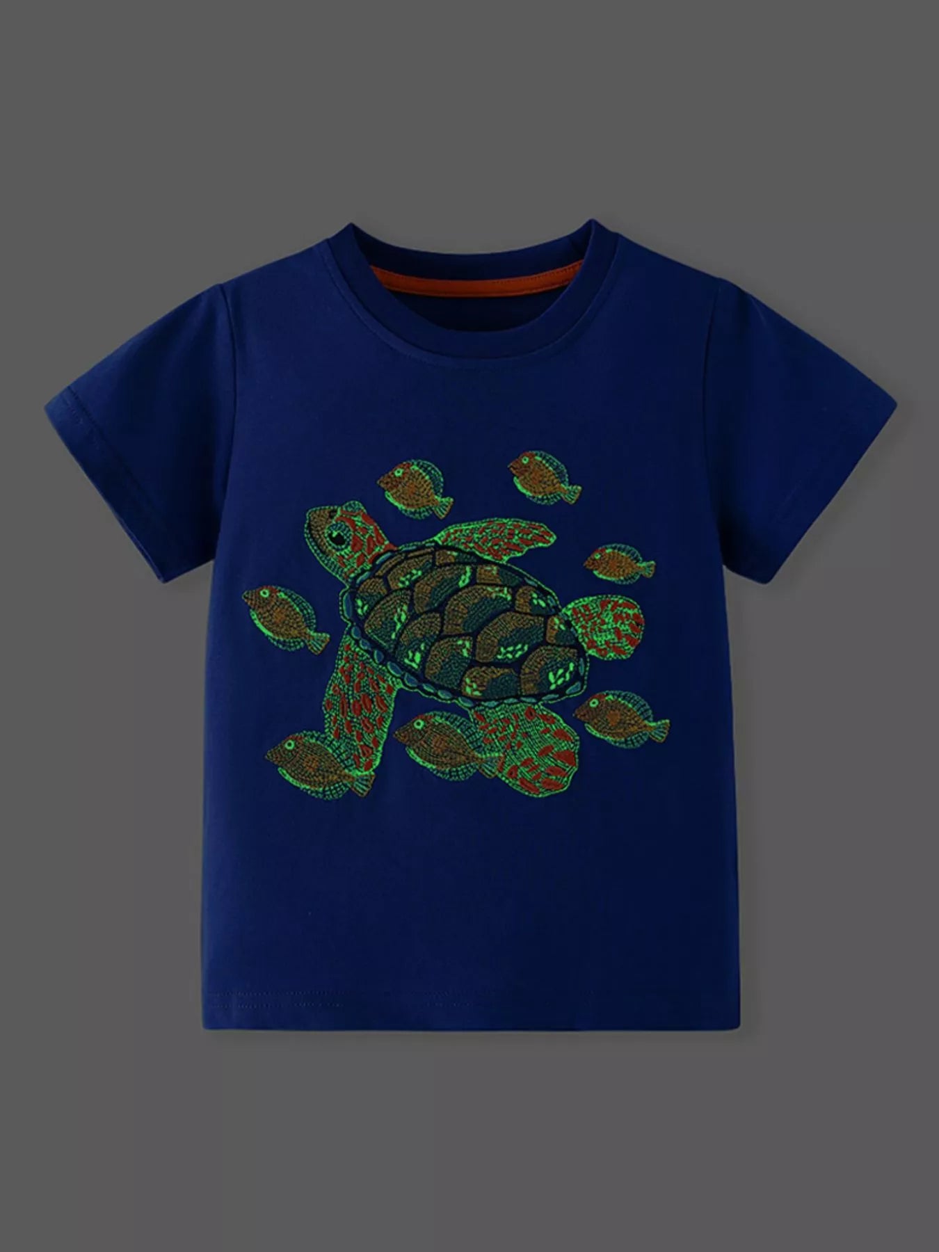 Front view of royal blue children's t-shirt with turtle graphic on dark background