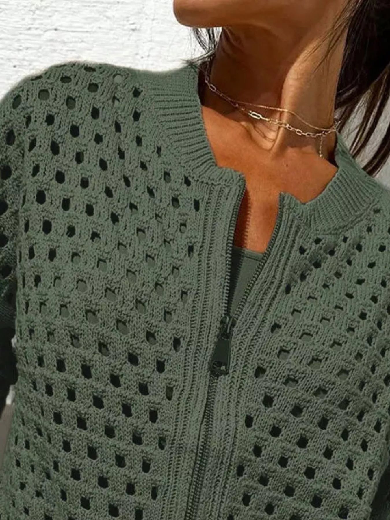 Close up of the army green crochet cardigan upper zip and openwork pattern