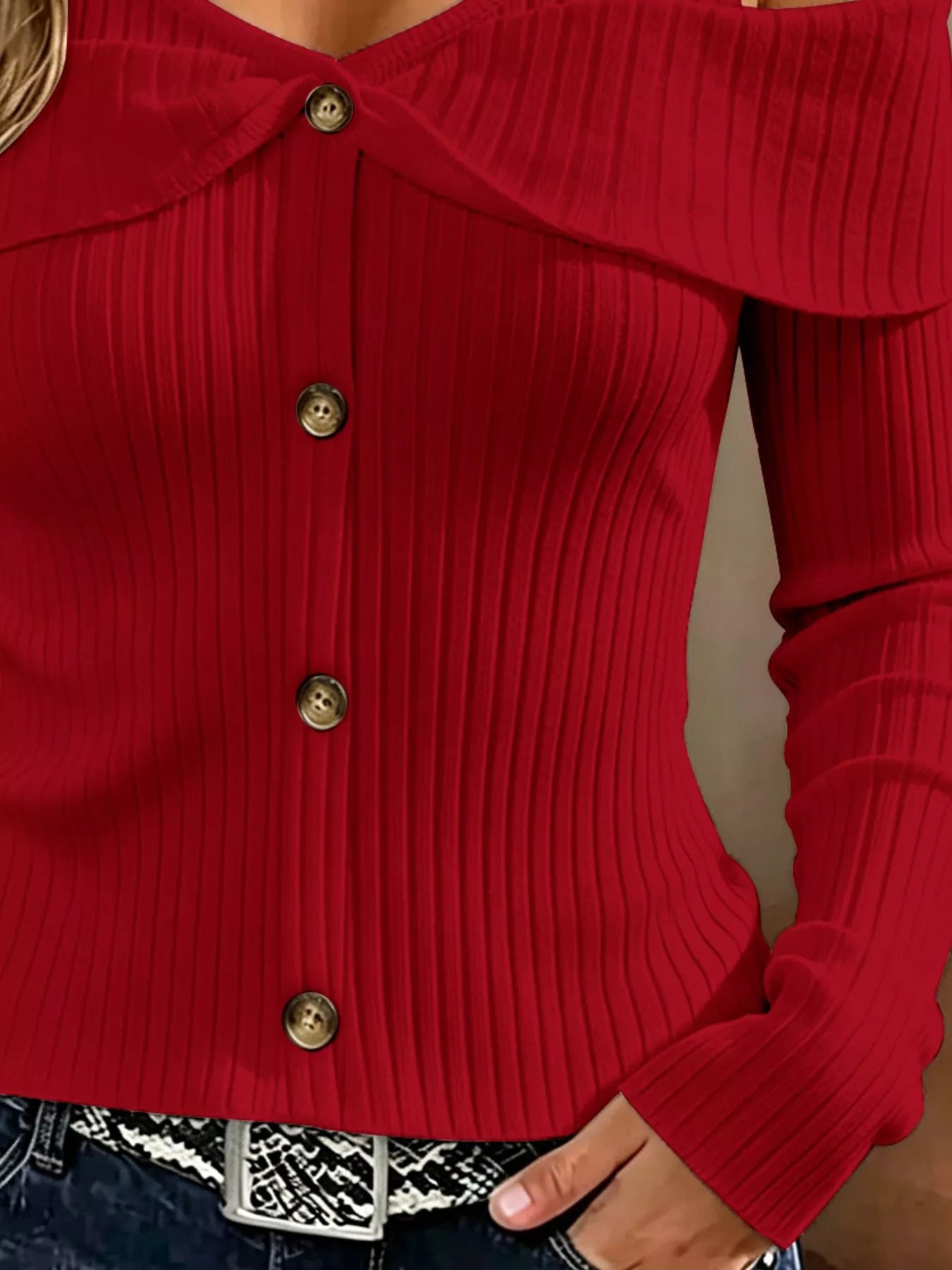 Close up of red cold shoulder ribbed knit top bodice showing ribbing and front buttons