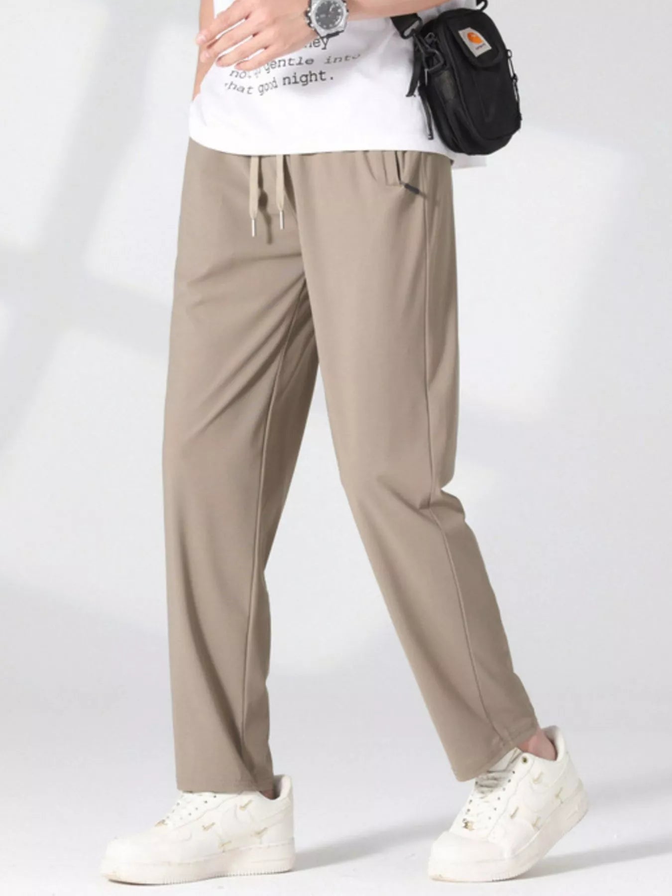 Men's khaki lightweight casual pants with a drawstring waist and pockets.