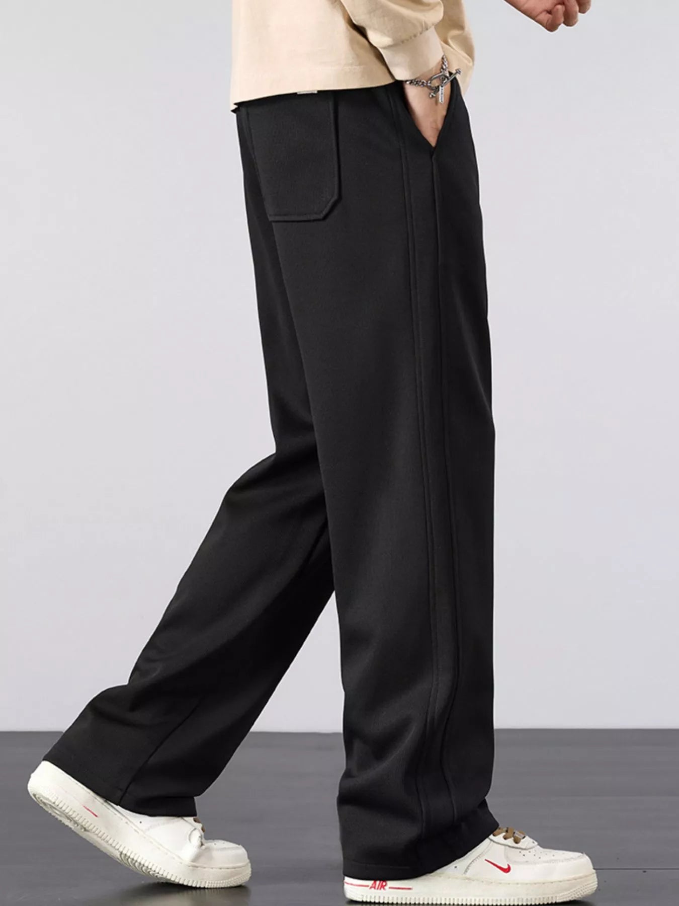 Men's casual loose fit pants with a drawstring waist and pockets.